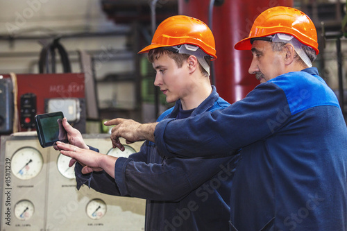 Men work on the old factory for the installation of equipment