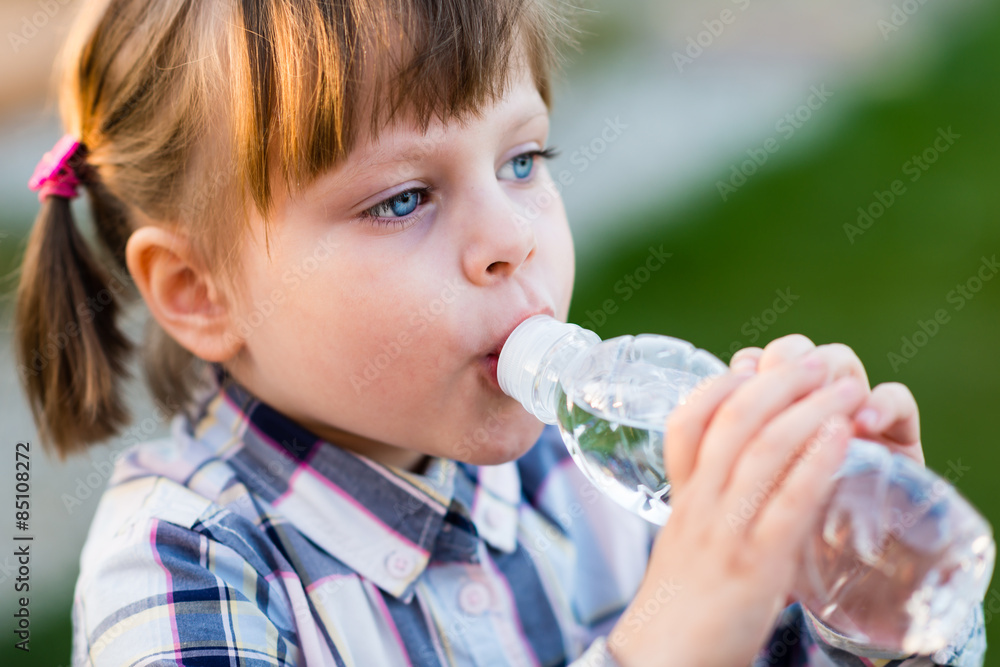 Girl drinking water. Cute little girl drinking water outdoor - very shallow deep of field (girl's eye is perfectly sharp) Girl drinking water. Cute little girl drinking water outdoor - very shallow deep of field (girl's eye is perfectly sharp)