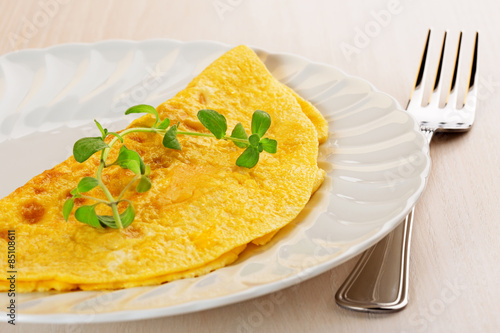 omelette garnished with a twig of marjoram