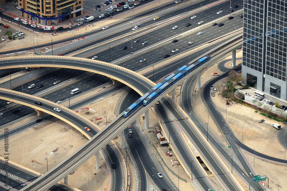 Two trains and road junction from above in Dubai Two trains and road junction from above in Dubai