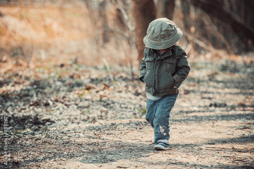 Funny little child walking in the woods Funny little child walking in the woods