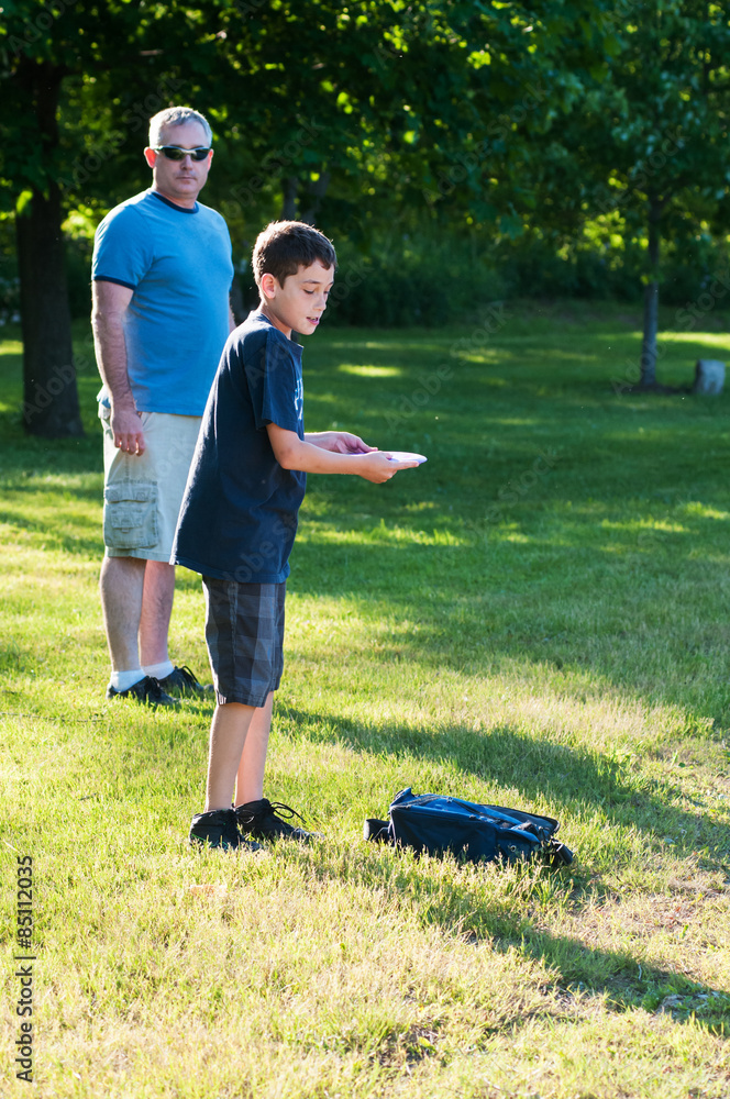 Fototapeta premium father and son playing disc golf