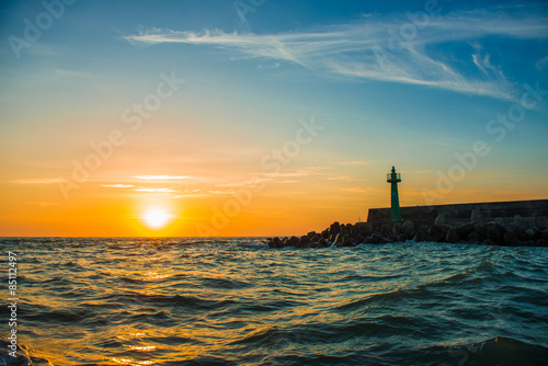 lighthouse under sunburst