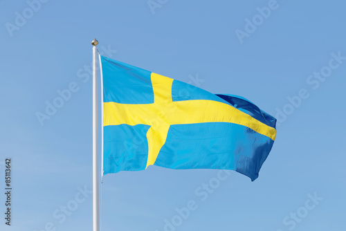 Swedish flag, blue and a yellow cross, blue sky