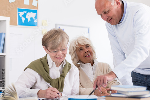 Teacher helping elder student © Photographee.eu