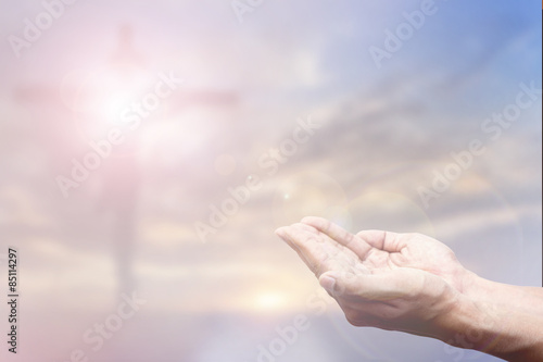Praying Hand and the cross blurred background © Art Stocker