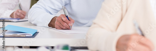 Students hands during writing exam photo