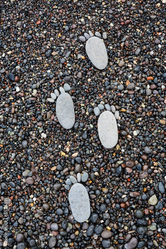 Footprint on wet sea pebbles