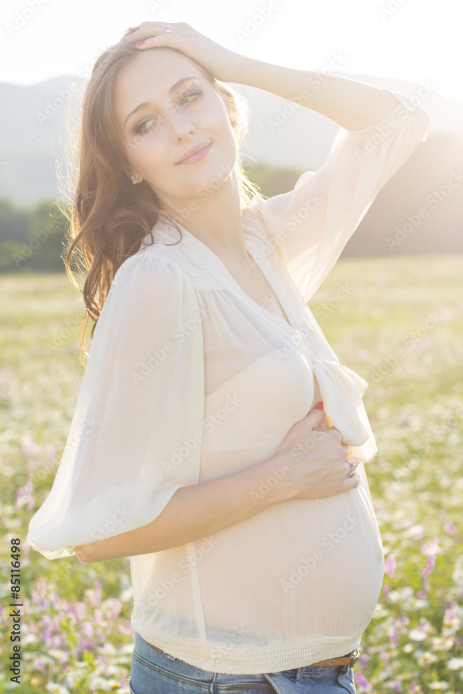 Happy pregnant woman in sunset lights Happy pregnant woman in sunset lights