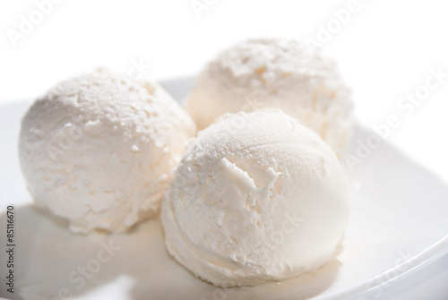 three balls of ice cream on a plate isolated