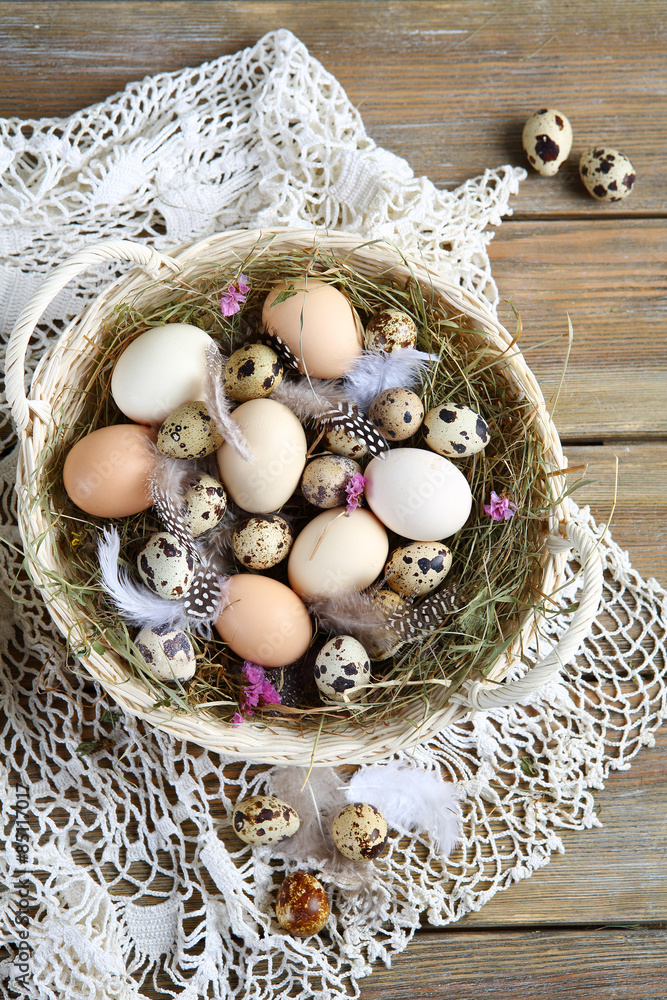 Easter eggs and feathers in the basket Easter eggs and feathers in the basket