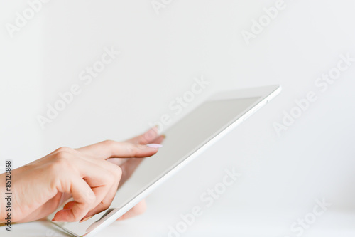 Woman hand browsing a digital tablet photo