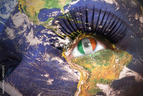 Photography woman's face with planet Earth texture and irish flag inside the eye
