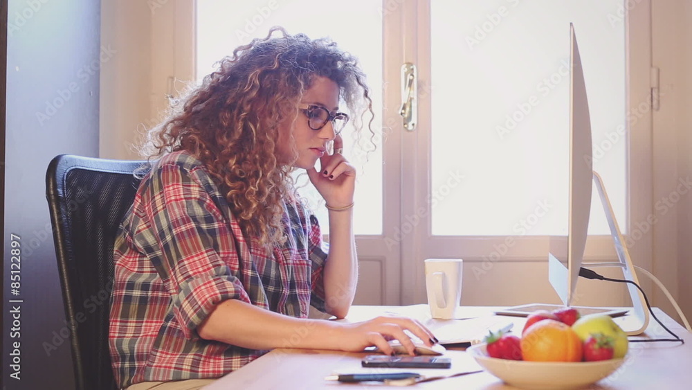 Young woman working at home or in a small office
Young woman working at home or in a small office