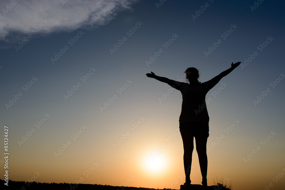 Woman embracing the sunset Woman embracing the sunset
