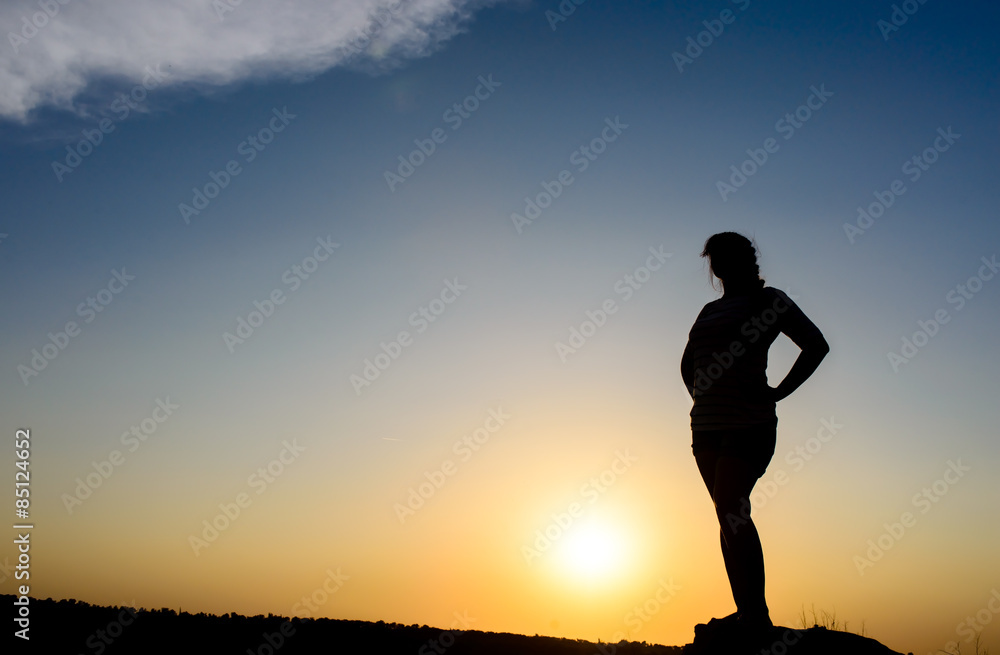 Woman embracing the sunset