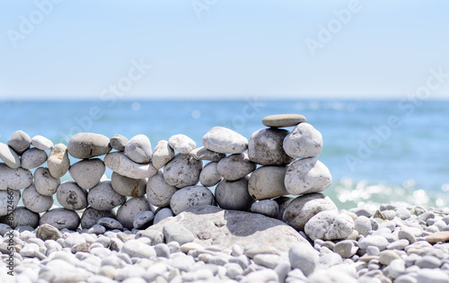 Stones stacked into a wall at the seaside