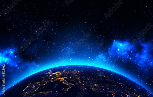Earth view from outer space background with night city lights, blue shining stars and galaxy