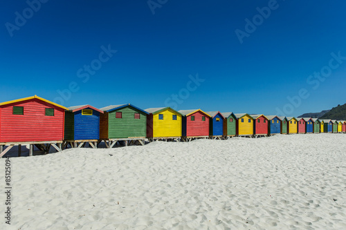 Colored Beach Houses in Muizenberg under blue sky © rompol