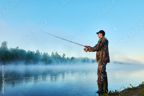 fisher fishing on foggy sunrise