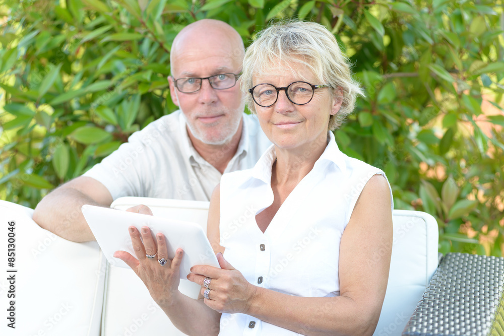 a couple of seniors look at a digital tablet a couple of seniors look at a digital tablet