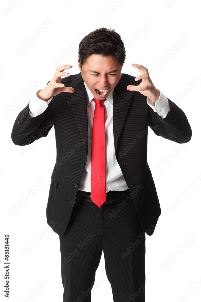 Frustrated businessman in a suit and red tie Frustrated businessman in a suit and red tie