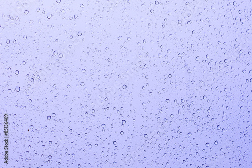 rain drop on the violet car glass in the rainy day 