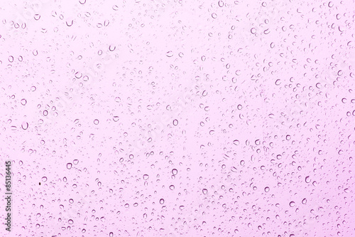 rain drop on the pink car glass in the rainy day 