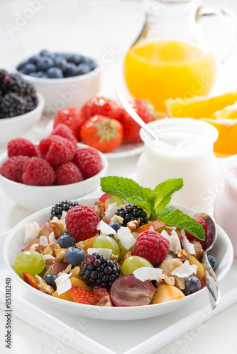 fruit salad in a bowl and various yoghurt  vertical