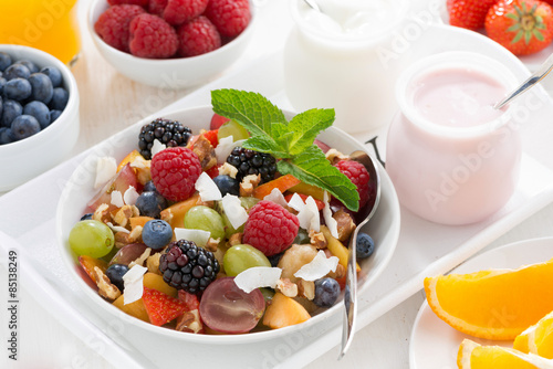 fruit salad in a bowl and various yoghurt