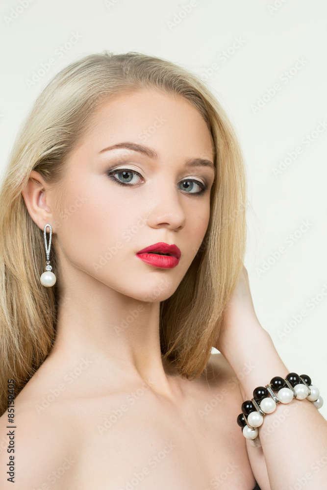beautiful girl with red lips. earrings and bracelets. fashion
