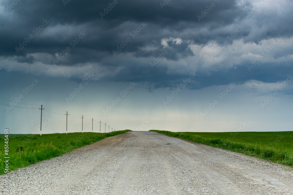 Dark Rain clouds Over Empty Road