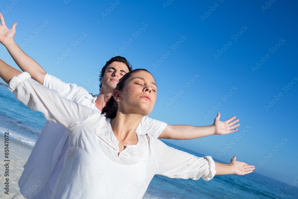Happy couple doing yoga beside the water Happy couple doing yoga beside the water
