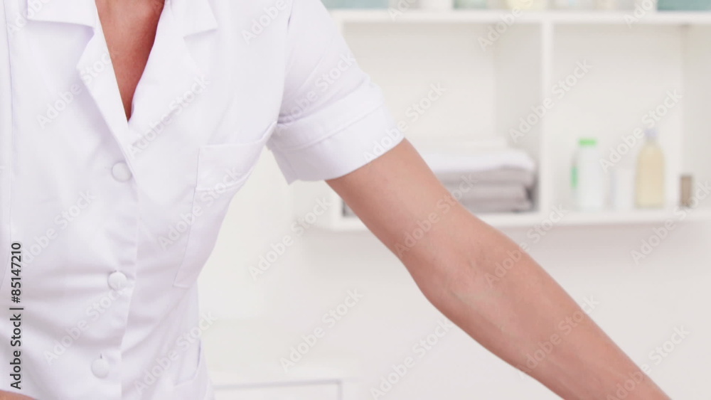 Physiotherapist doing back massage to her patient Physiotherapist doing back massage to her patient