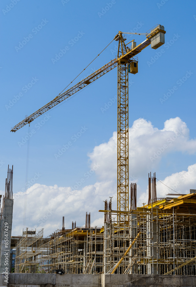 Crane and building construction against blue sky