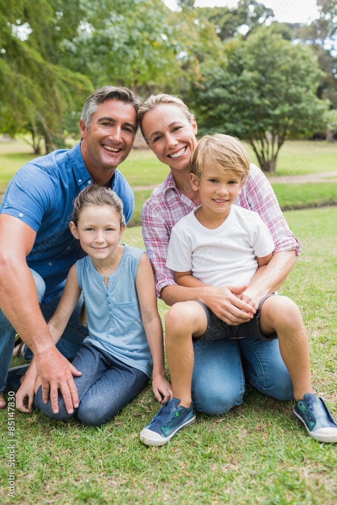 Happy family smiling at the camera Happy family smiling at the camera