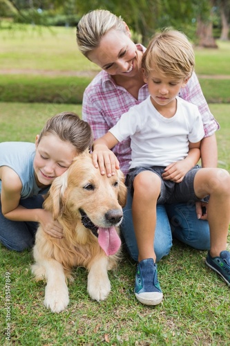 Happy family in the park with their dog