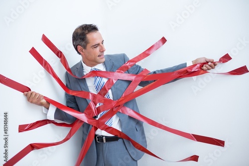 Businessman trapped by red tape