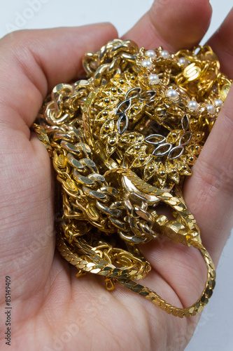 gold jewelry in human hand
