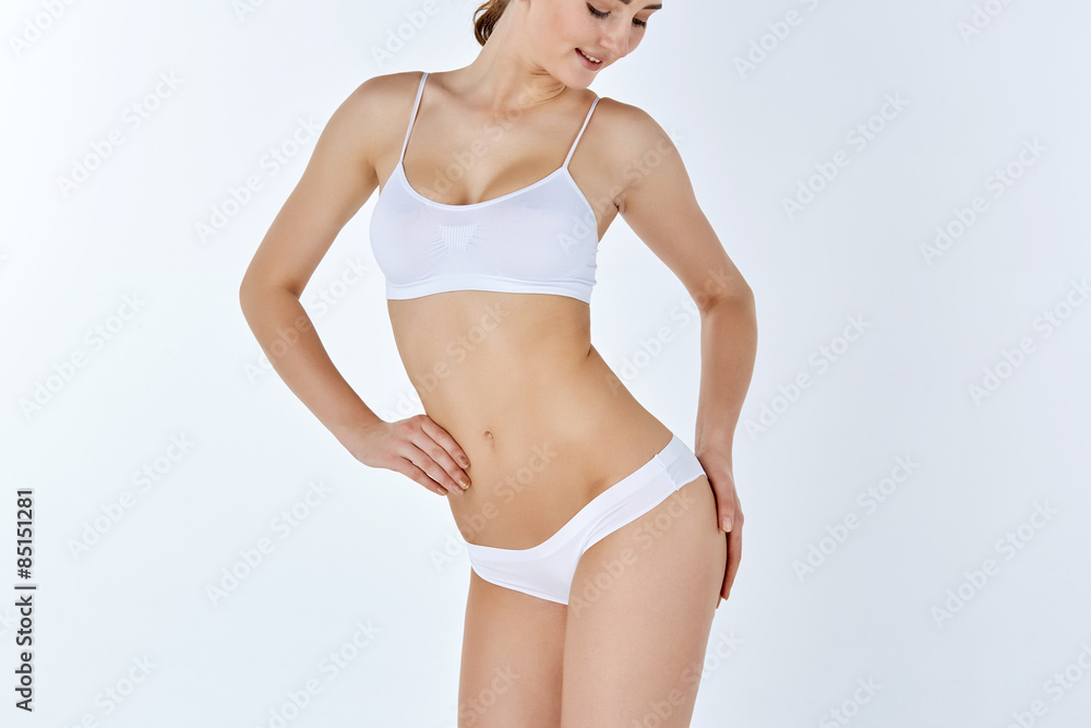 Fototapeta premium Young, slim, healthy and beautiful woman in white lingerie