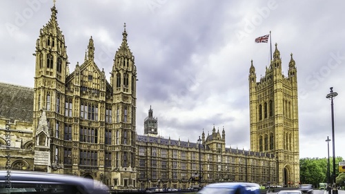 Timelapse view of the House of Parliament in London, also known as Wesminster Palace. The Union jack flies in the wind at the top of Victoria tower photo
