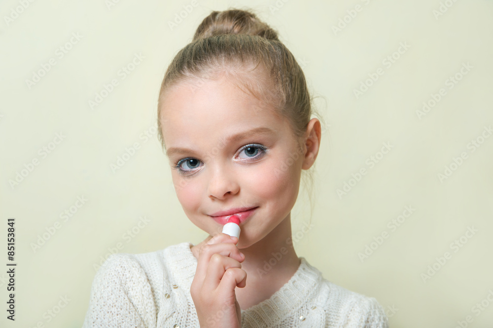 Fashion little girl applying make up. Mascara, eye shadow, lip g Fashion little girl applying make up. Mascara, eye shadow, lip g