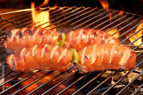 Fatty Sausages On The Hot Barbecue Flaming Charcoal Grill