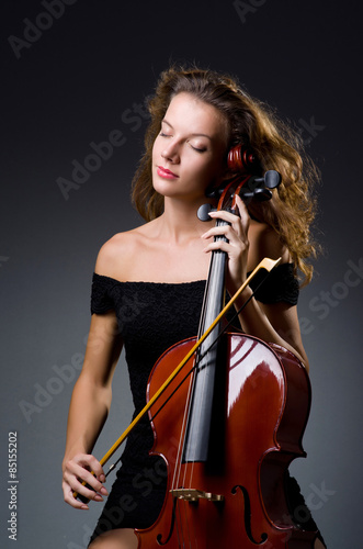 Female musical player against dark background