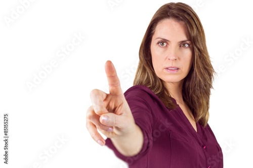 Serious woman pointing her finger at camera 