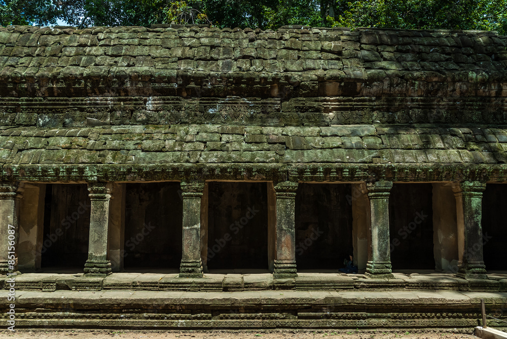 frontal sight of a gallery with pillars and false vault in the archaeological ta prohm place in siam reap, cambodia