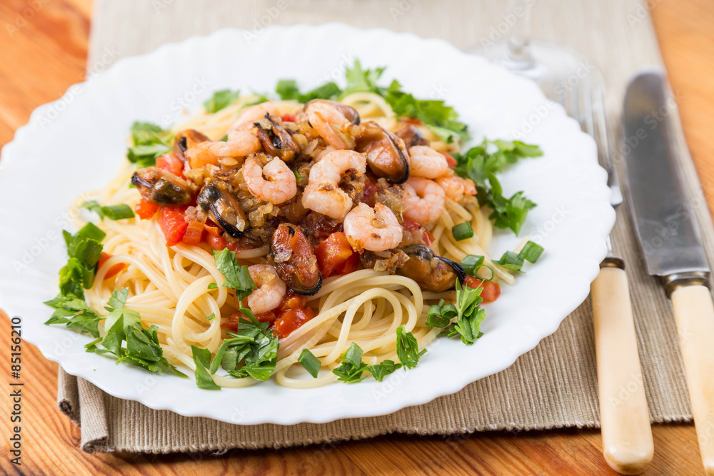 pasta with seafoods and white wine on napkin