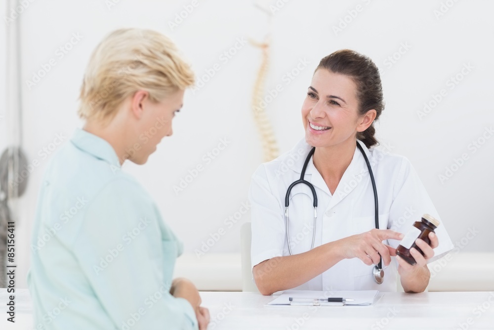 Doctor explaining treatment to her patient Doctor explaining treatment to her patient