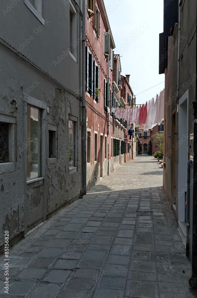 Narrow street in Murano island, Italy