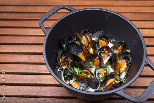 hot mussels with sauce in coast iron